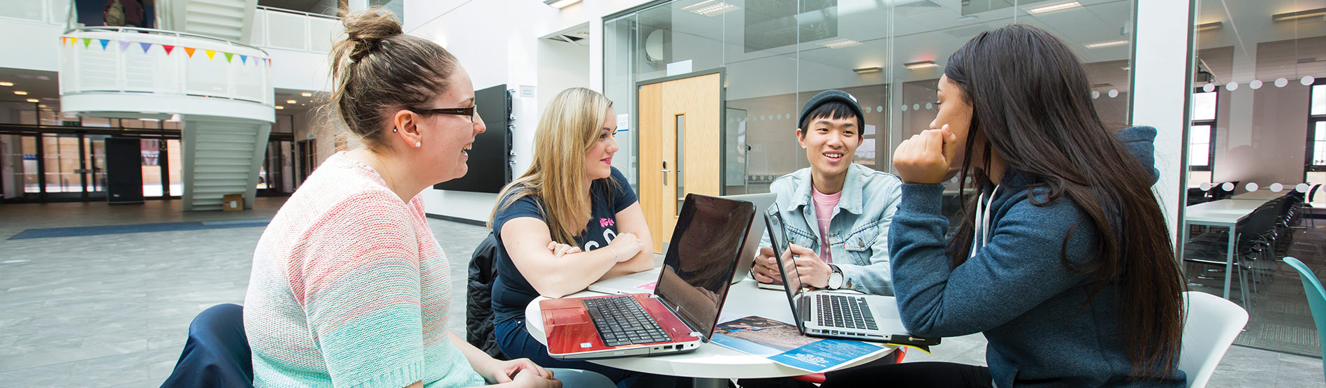 Students around a table in the School of Management at Swansea University.