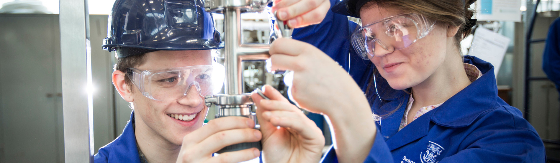 Engineering students adjusting equipment.