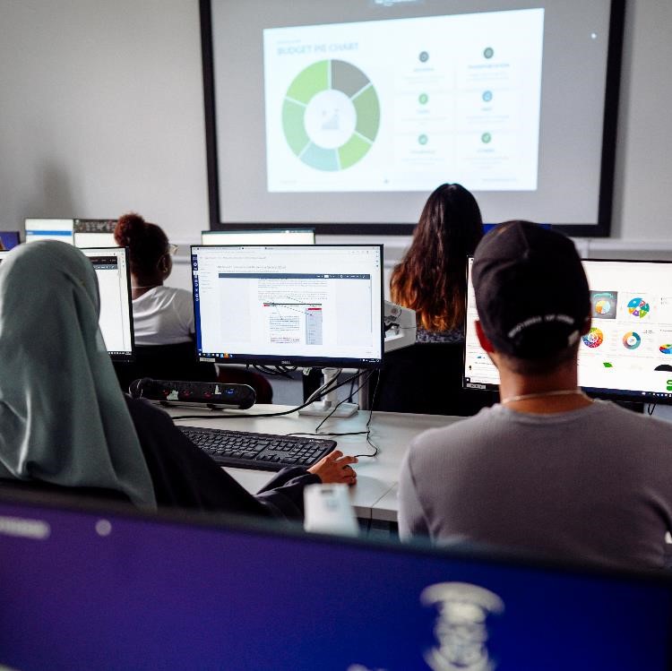 Students on computers in classroom.