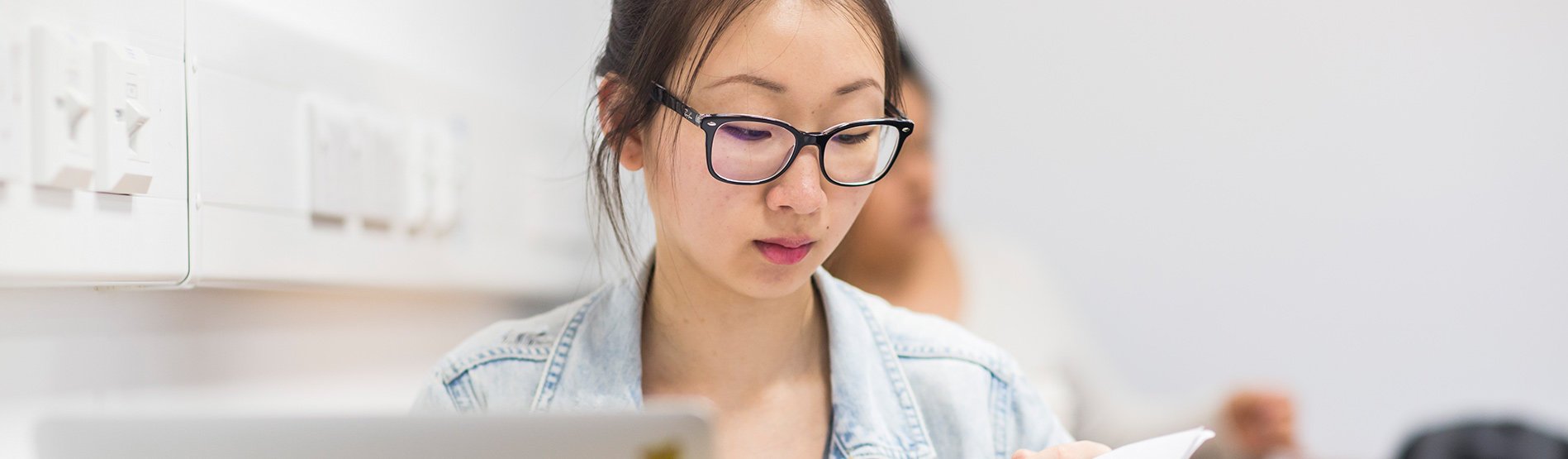 Student studying and wearing glasses.