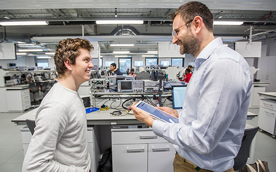 Student and lecturer in an Engineering lab.