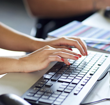 Hands on a laptop keyboard