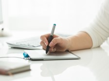 Person writing on a piece of paper