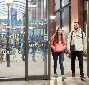 Two students walking through Engineering on Bay Campus