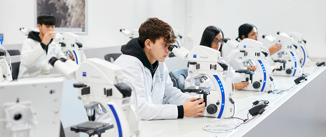 Engineering students in white lab coats 