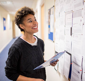 student looking at a notice board