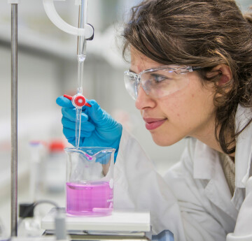 Female student with lab equipment