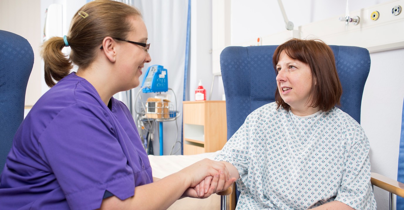 student nurse helping patient