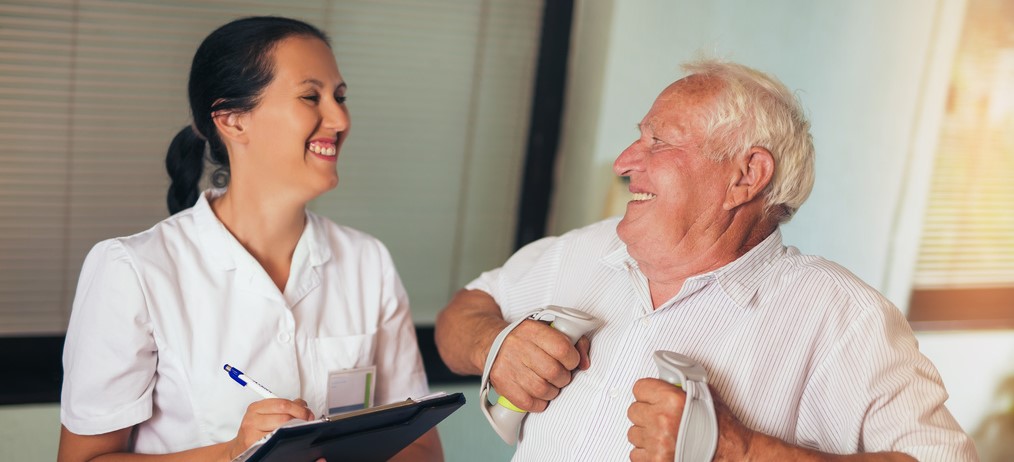 Occupational Therapist helping woman with fine motor skills