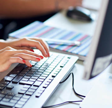 person typing on a computer keyboard