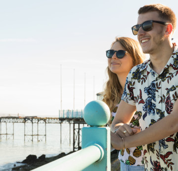 Students stood by the pier in the sun