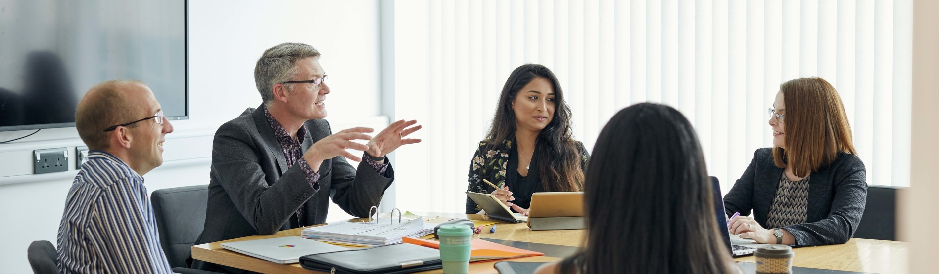 Staff speaking at a meeting