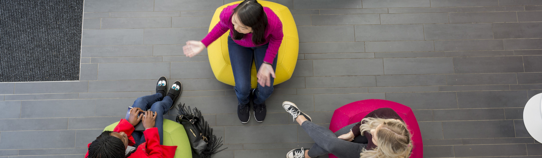 Students sitting on bean bags in the Law department