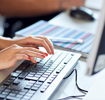 Hands typing on a keyboard